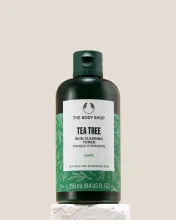 The Body Shop Tea Tree Skin Clearing Toner 250ml displayed on a clean pedestal against a soft background