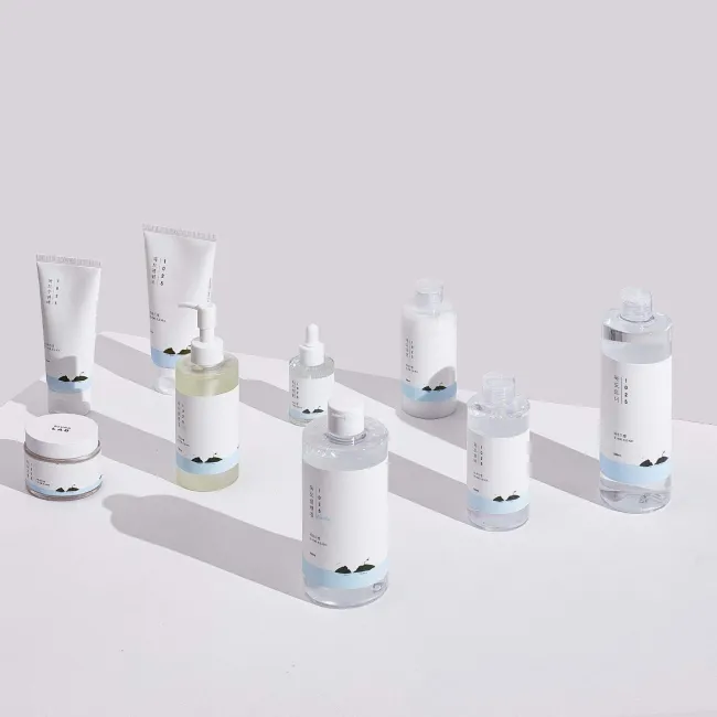Korean skincare collection with minimalist white and blue packaging, featuring cleansers, toners, and essences for clean beauty routines.