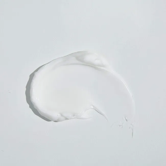 Smooth white cream texture on a clean background, ideal for clean skincare routines.