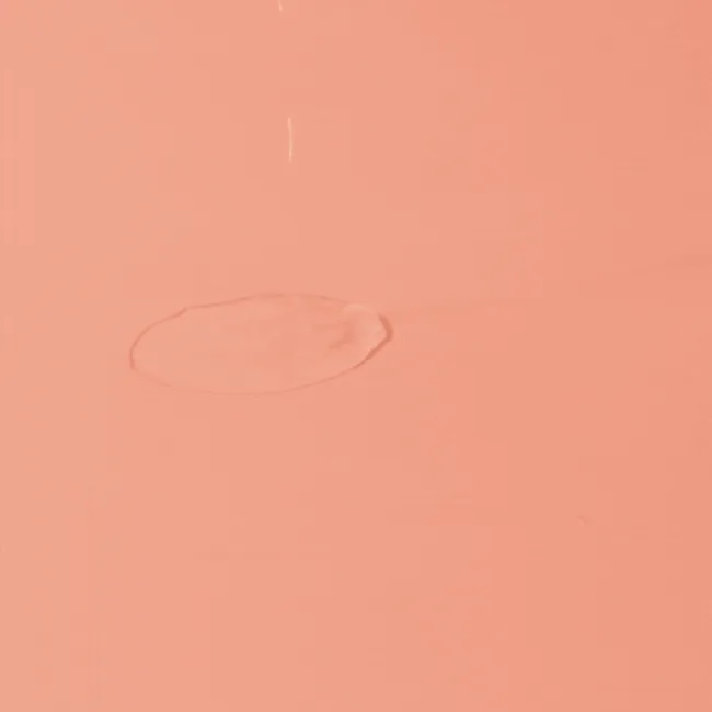 Light and watery texture of centella 3% PHA gentle liquid exfoliating serum for pore care on a white background.
