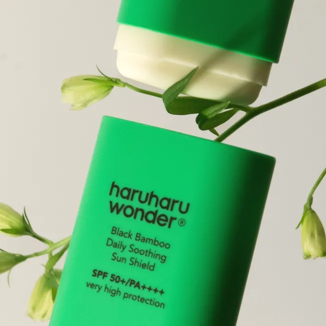 A green haruharu wonder black bamboo daily soothing sun shield sun stick SPF 50+ PA++++ with very high protection and 20g weight on a white background.