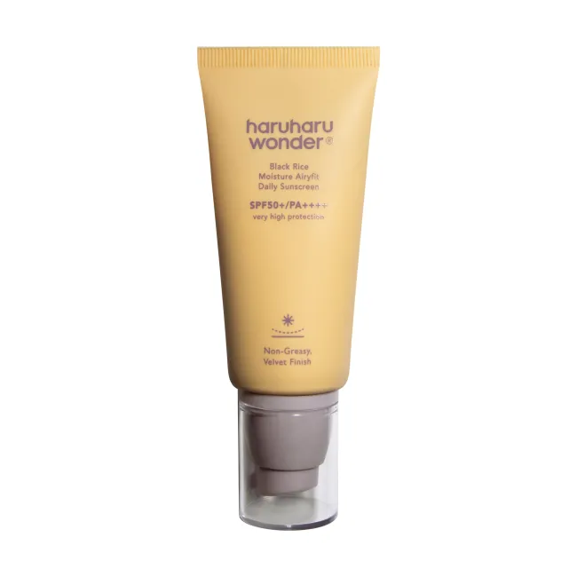 A yellow tube of BLACK RICE moisture airyfit daily sunscreen with SPF50+ PA++++ by haruharu wonder with very protection non-greasy, velvet finish on a white background