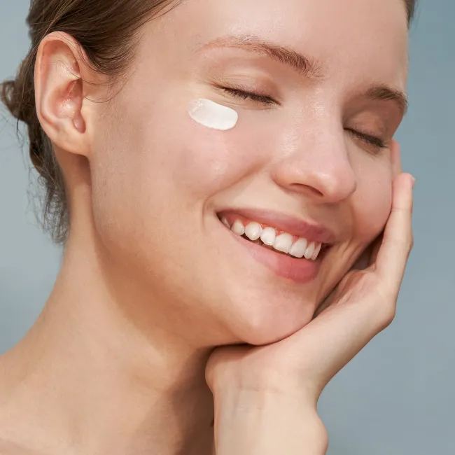 A close up of a woman applied haruharu wonder BLACK RICE pure mineral relief daily sunscreen with SPF50+ PA++++ protection, for sensitive skin