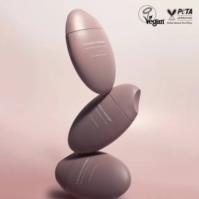 three stacked 50ml of haruharu wonder Black Rice 10 Hyaluronic Cream bottles on a light pink background with PETA and vegan approval logo.