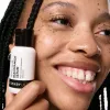 Model holding a bottle of Niacinamide Serum