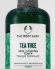 Close-up of The Body Shop Tea Tree Skin Clearing Toner, droplets on bottle against clean backdrop.