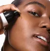 Person applying 15% Vitamin C + EGF Serum to face with close-up focus on skin texture
