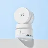 Round Lab 1025 Dokdo Cream jar with minimalist design, white lid, and mountain graphic on label against light blue background
