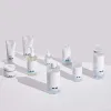 Clean skincare products with minimalist design, featuring clear bottles and white tubes for K-Beauty routines.