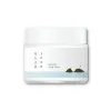 Korean skincare cream jar with minimalist design and island illustration