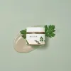 Clean skincare cream with green leaf accents, inspired by Korean natural ingredients