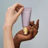 Tube of haruharu wonder BLACK RICE pure mineral relief daily sunscreen with SPF50+ PA++++ protection, 50ml size for sensitive skin into a palm of a person.