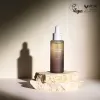 haruharu wonder black rice facial oil dropper bottle on a stone surface with a neutral background, featuring PETA Vegan approval logo